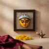 Close-up of a vibrant handmade Terracotta Durga Wall Hanging on a jute background, showcasing intricate details of Maa Durga's face, a prime example of Bengal crafts.